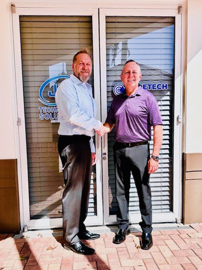 Press photo of Russell Zimny and Justin Kelm standing in front of their joint office.