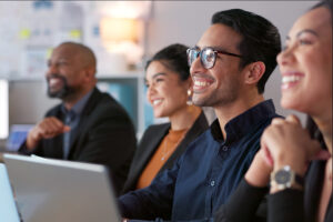 Smiling business colleagues sitting during a presentation.