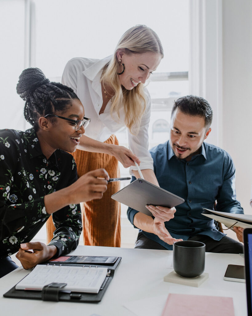 Business colleagues discussing in meeting with a digital tablet.