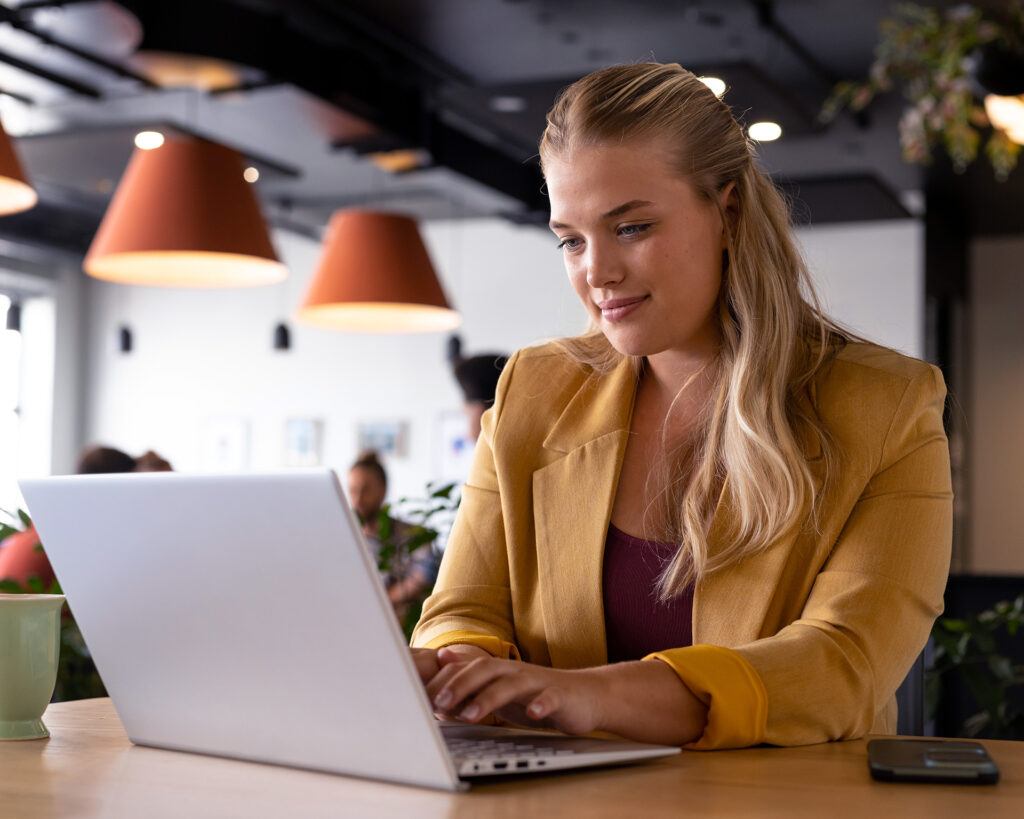 Businesswoman working at a cafe on her laptop.